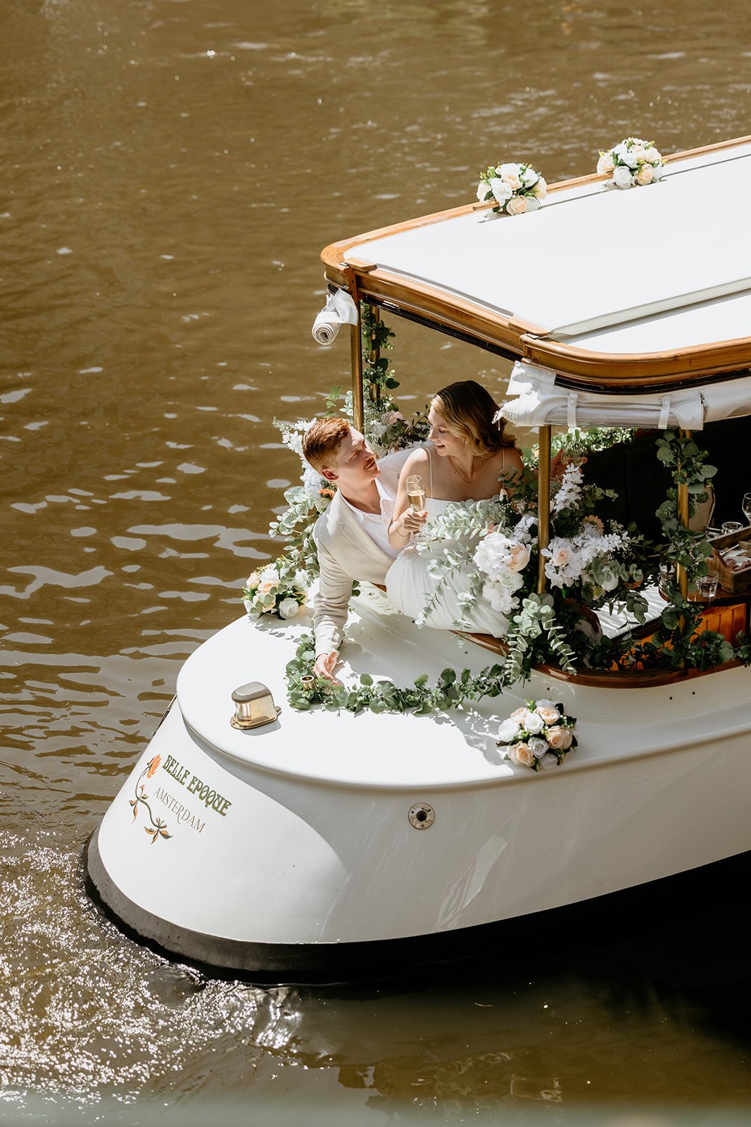 White boat prepared for an Amsterdam boat wedding and ceremony with intimate boat wedding styling on the canal