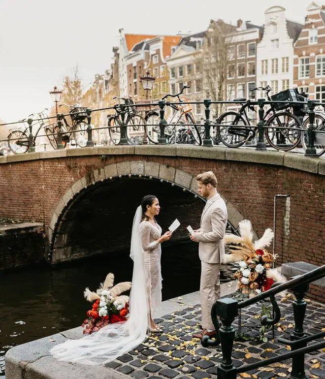 Bridal couple standing on a quiet pier during their elopement in Amsterdam ceremony