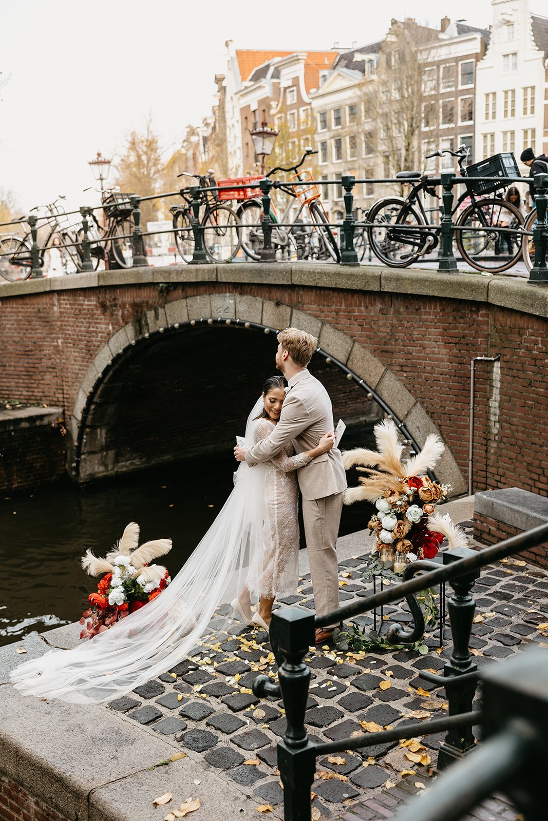Couple hugging during their intimate ceremony on a canal pier in Amsterdam