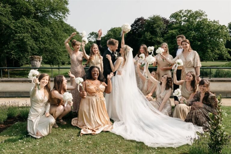 Bridal couple smiling as guests cheer during an outdoor park wedding ceremony in Amsterdam