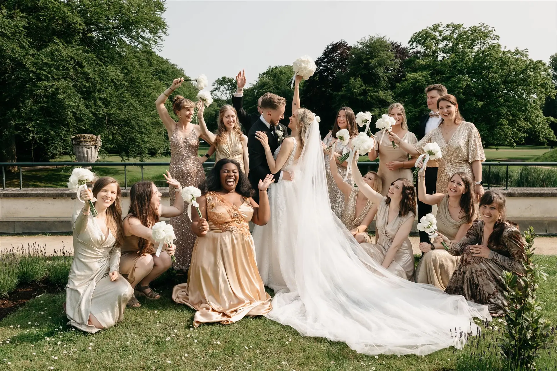 Bridal couple smiling as guests cheer during an outdoor park wedding ceremony in Amsterdam