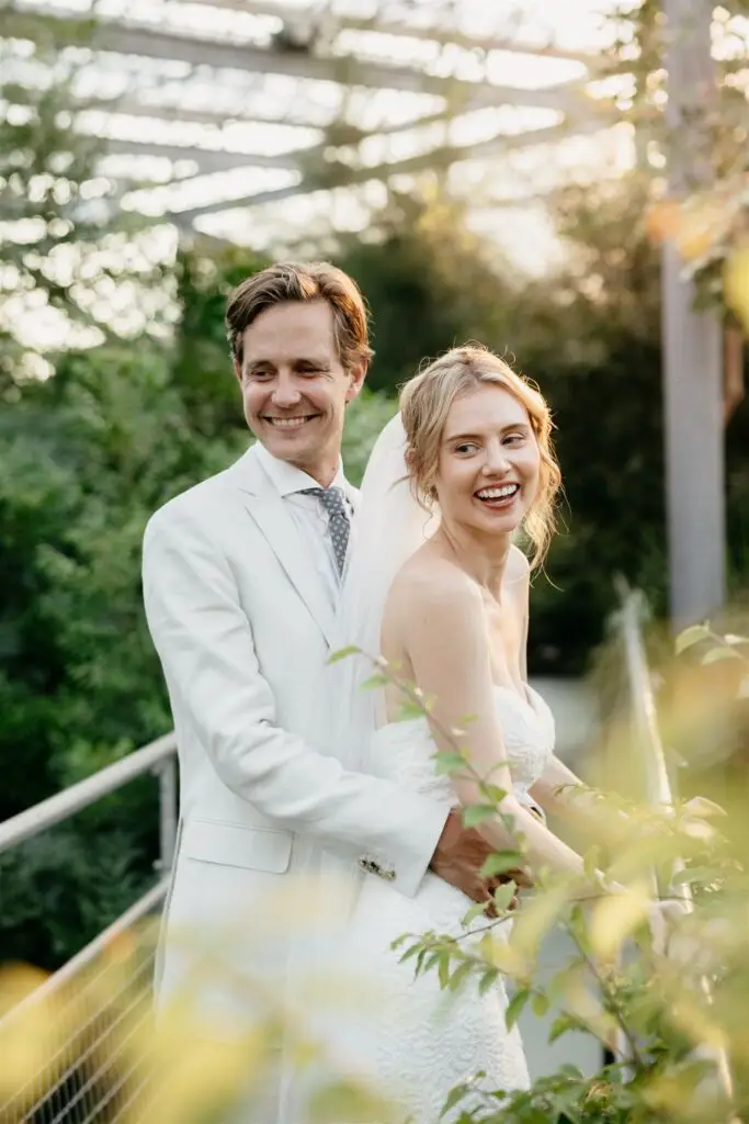 Couple embracing inside a greenhouse during a botanical garden elopement in Amsterdam