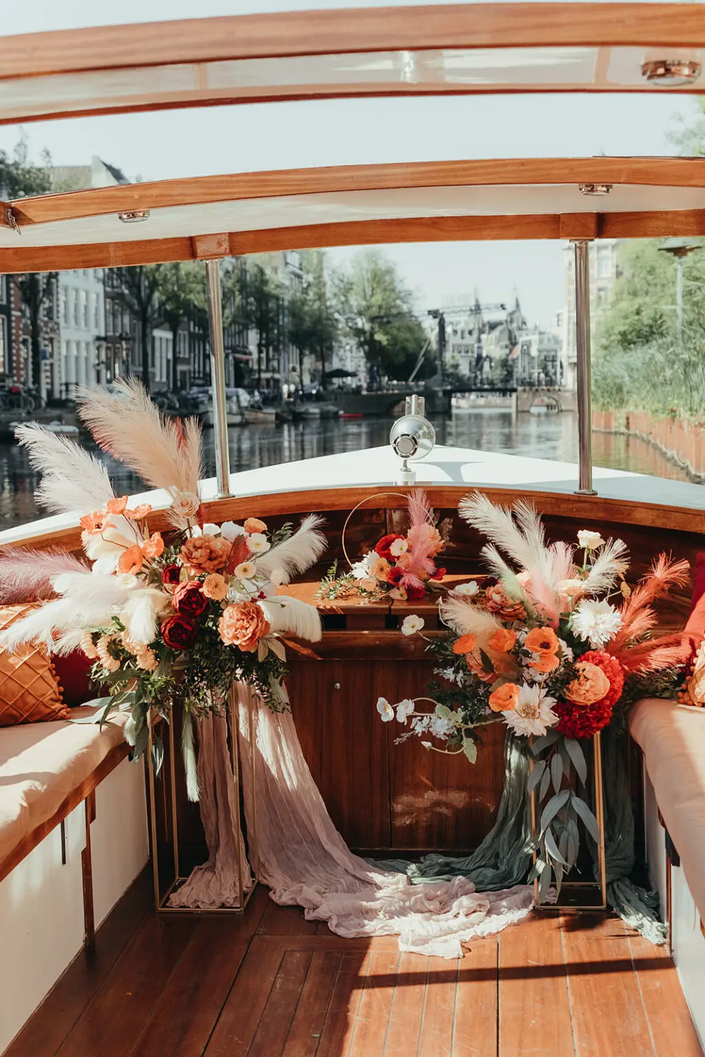 Floral ceremony styling inside a private canal boat during an Amsterdam elopement experience