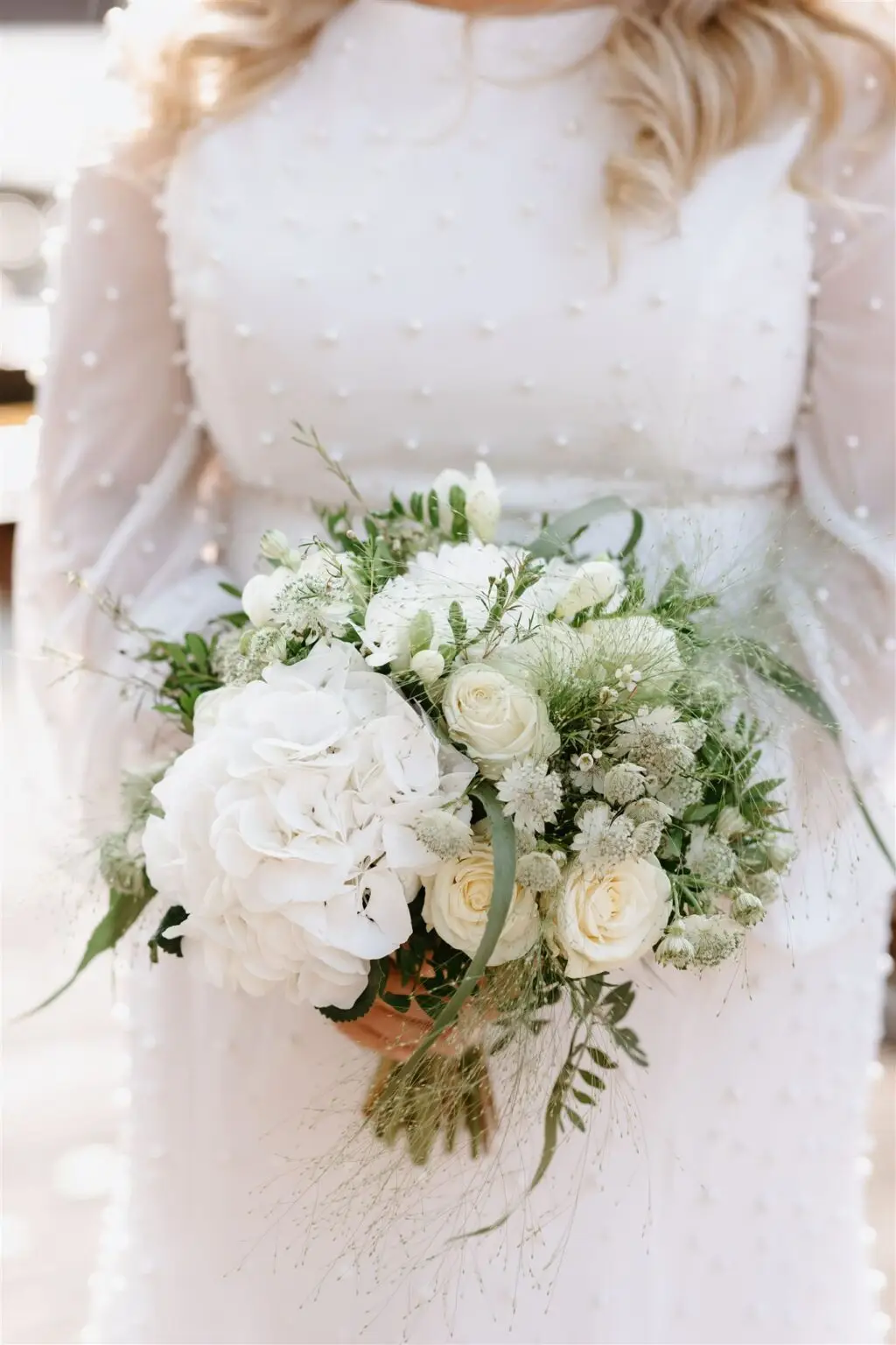Bride holding a soft white floral bouquet during an intimate Amsterdam elopement ceremony