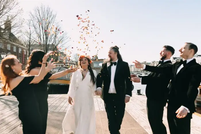 Couple celebrating with guests after an intimate Amsterdam elopement ceremony by the waterfront