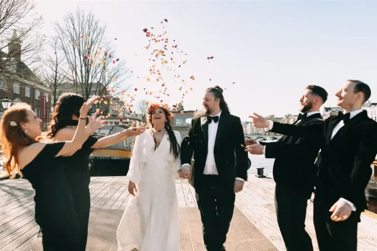 Couple celebrating with guests after an intimate Amsterdam elopement ceremony by the waterfront