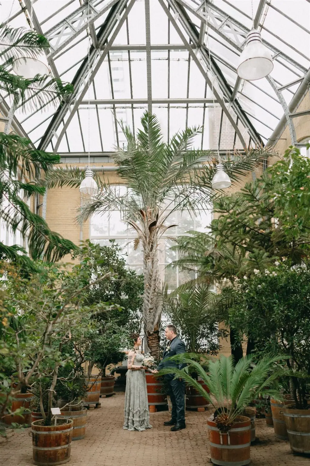 Couple standing inside a greenhouse at Hortus Botanicus Amsterdam during a botanical garden elopement