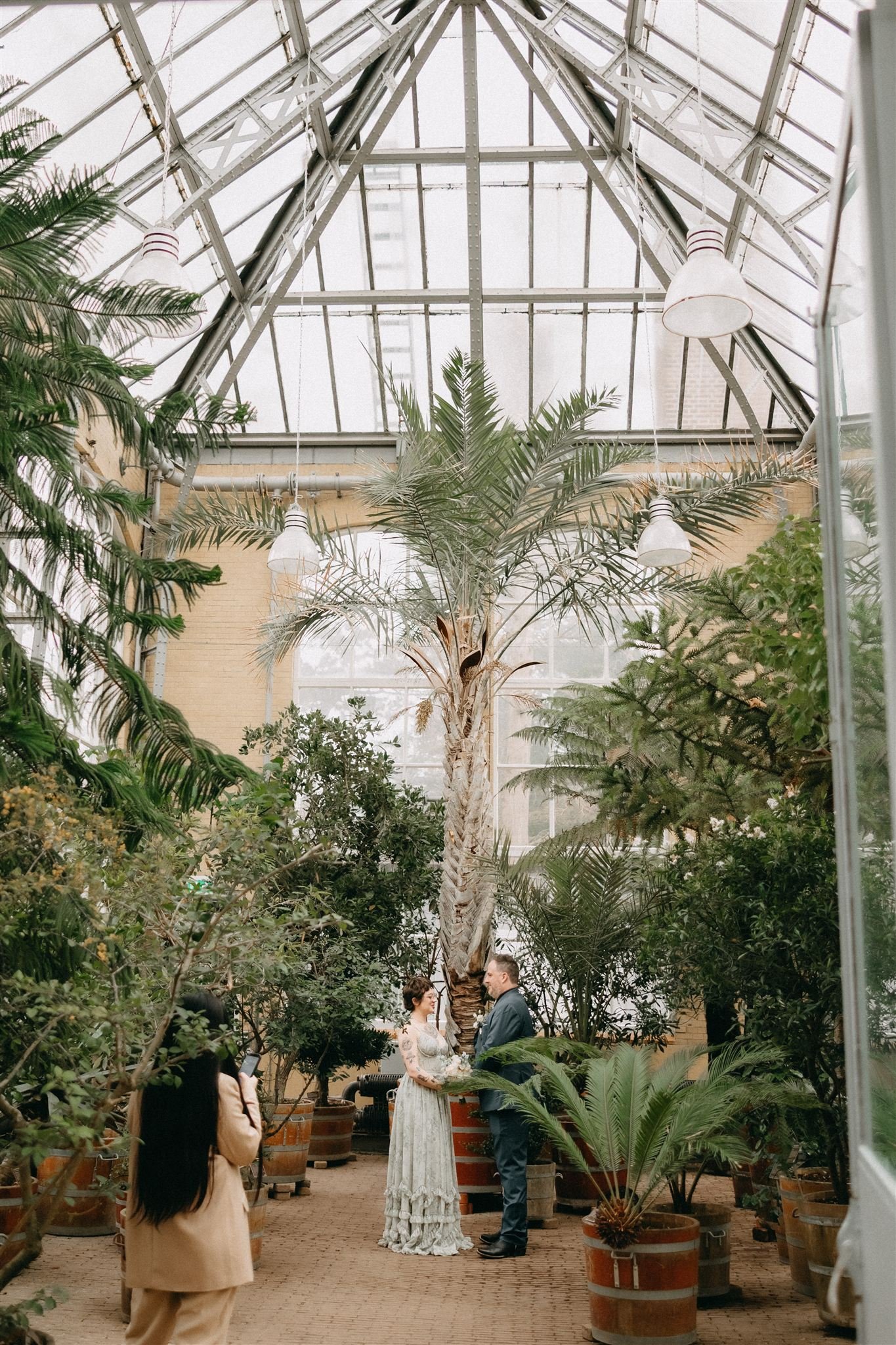 Couple exchanging vows during a botanical garden elopement ceremony in Amsterdam