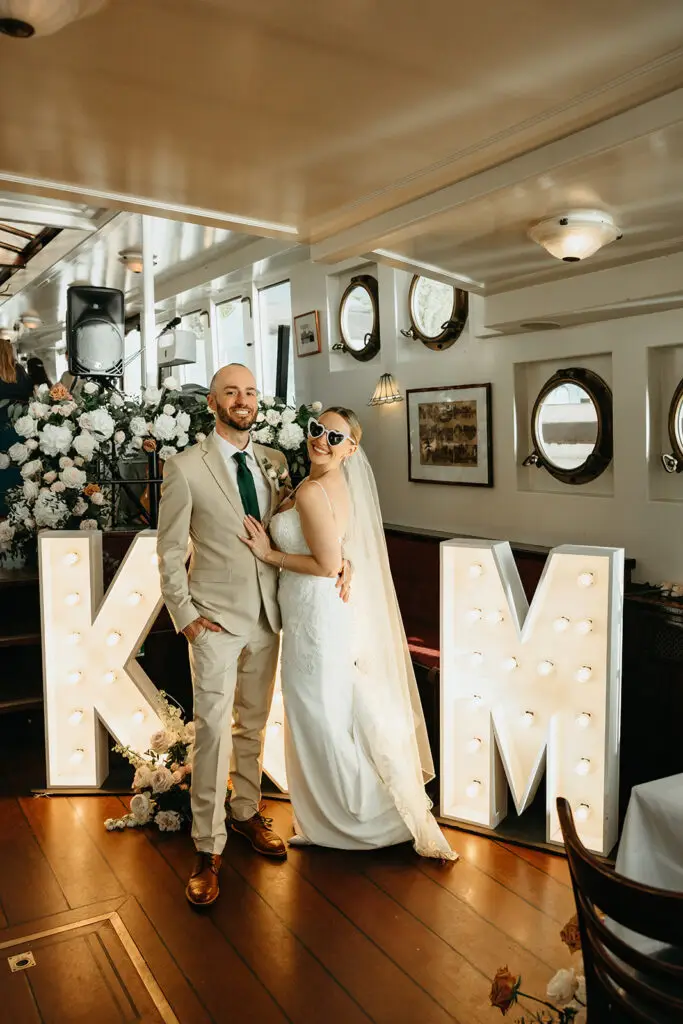 Couple celebrating inside a private canal boat during an Amsterdam elopement reception