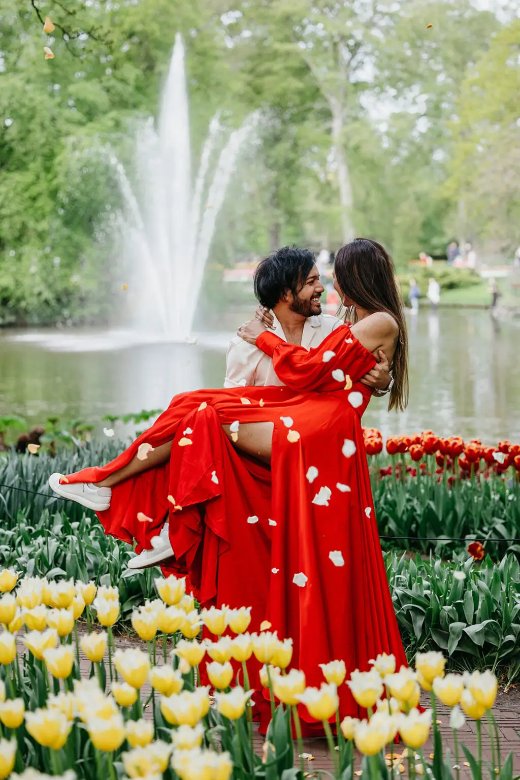 Couple embracing among tulips near Amsterdam during spring bloom season in the Netherlands