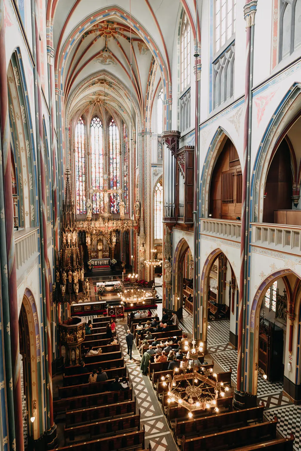 Interior of De Krijtberg church in Amsterdam with guests seated during a wedding ceremony