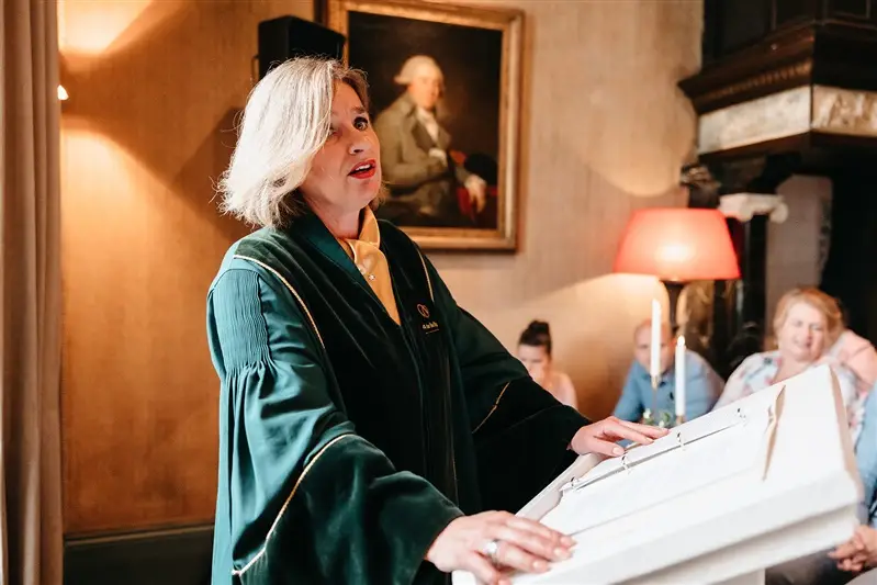 Wedding officiant leading an intimate civil ceremony inside a historic Amsterdam venue