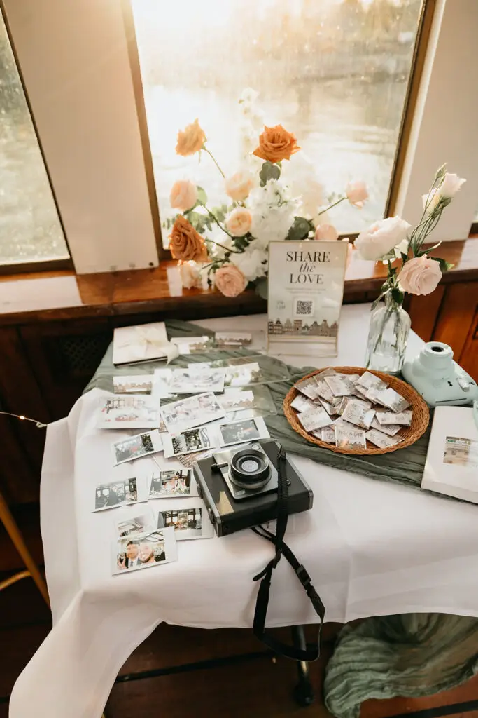 Guest experience table with instant photos and personalized details during an Amsterdam elopement celebration