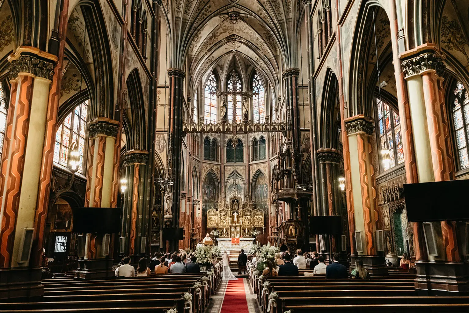 Wide interior view of Onze Lieve Vrouwekerk at Keizersgracht Amsterdam during a wedding ceremony with guests seated