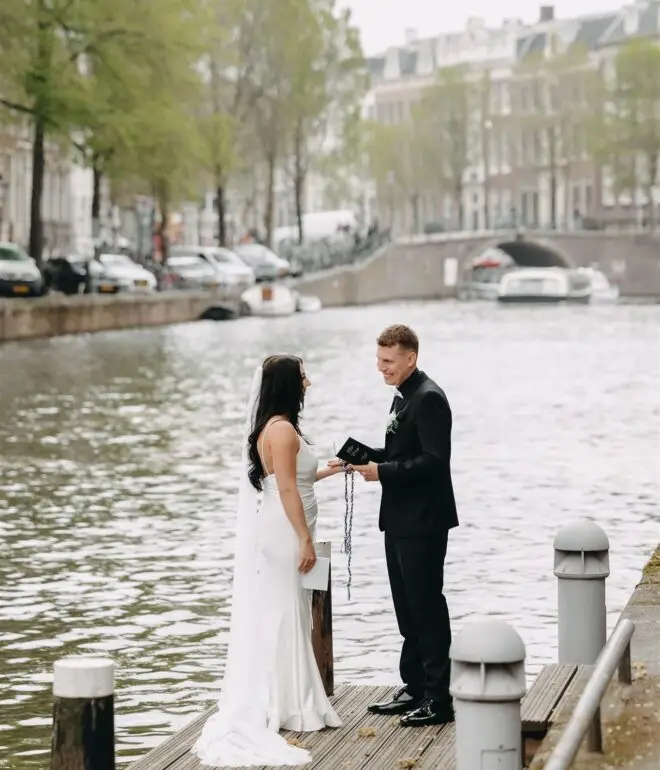 Couple exchanging vows by the canal during an intimate elopement in Amsterdam