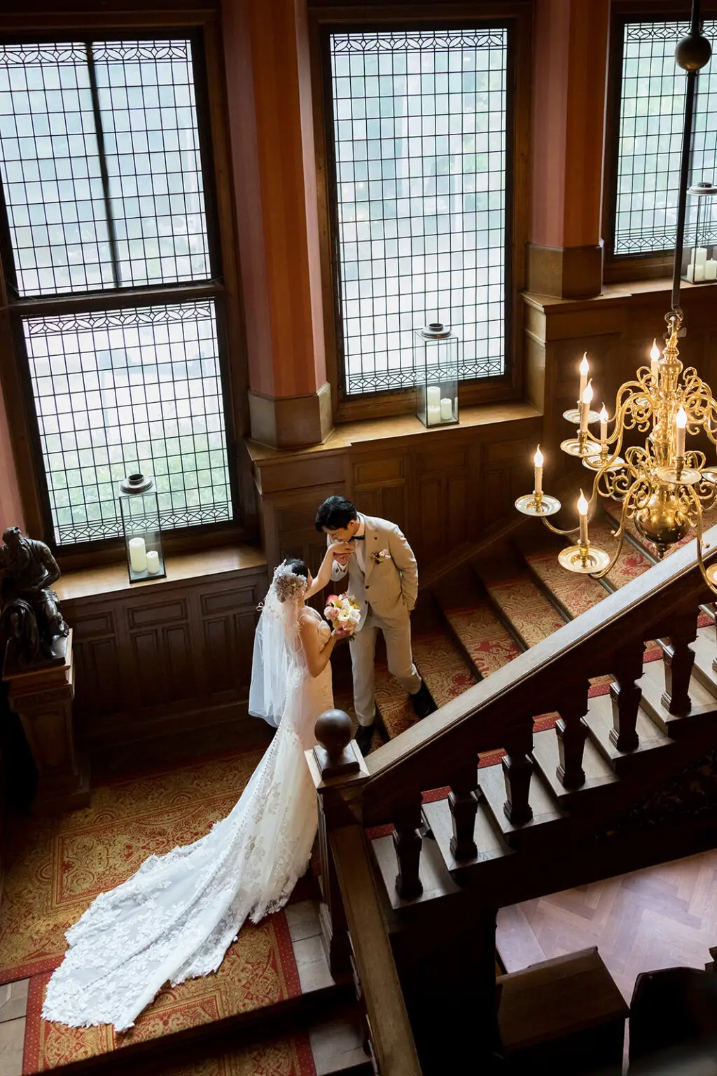 Couple standing on a staircase inside Landgoed Duin & Kruidberg historic house during an intimate elopement near Amsterdam