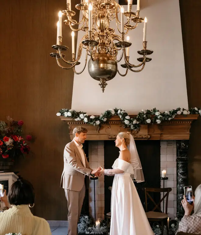 Couple exchanging vows inside an elegant historic house during an intimate elopement in Amsterdam