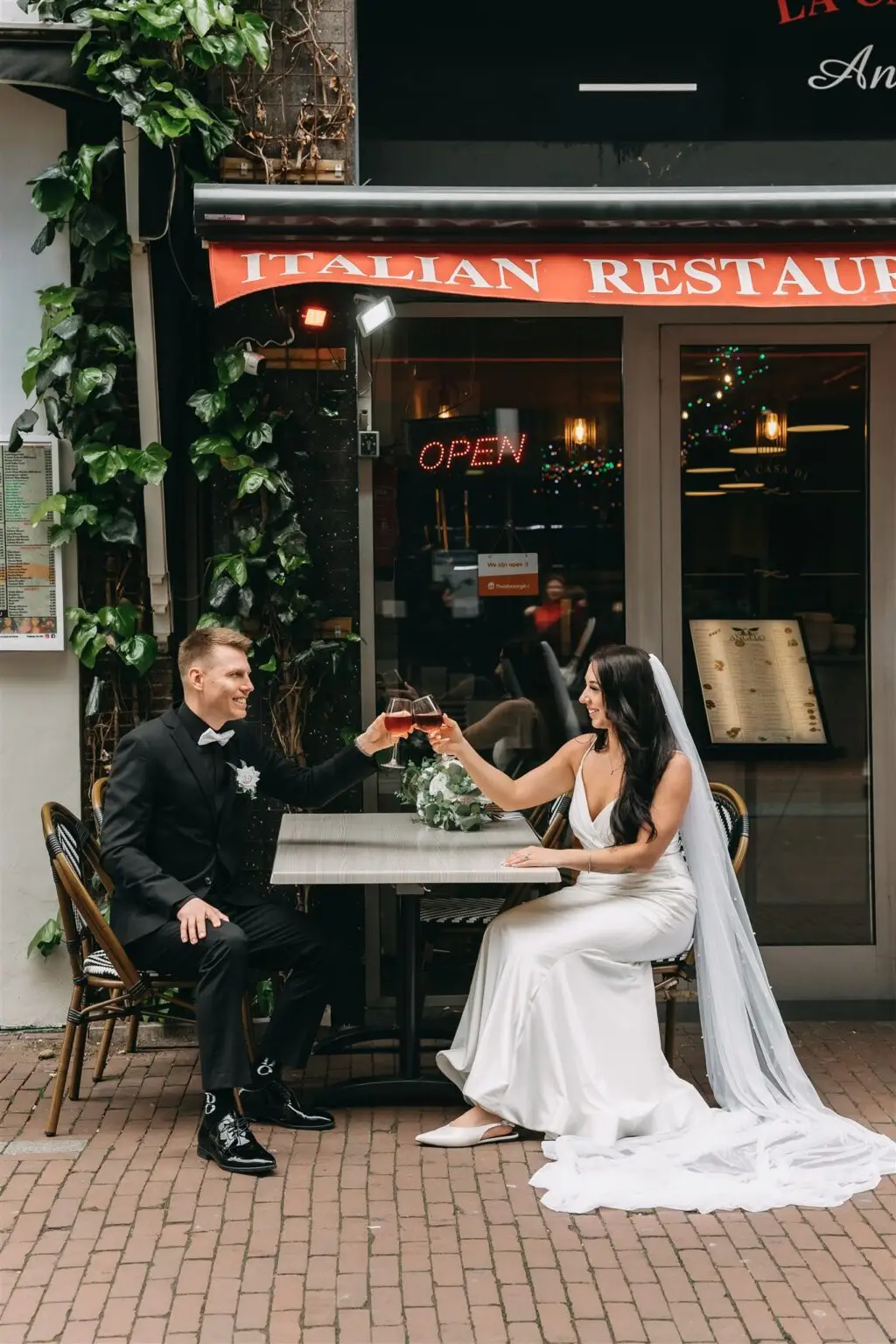 Couple having drinks outside a restaurant in Amsterdam after their intimate city elopement