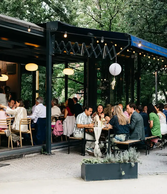 Outdoor restaurant terrace during an intimate Amsterdam elopement dinner celebration with guests