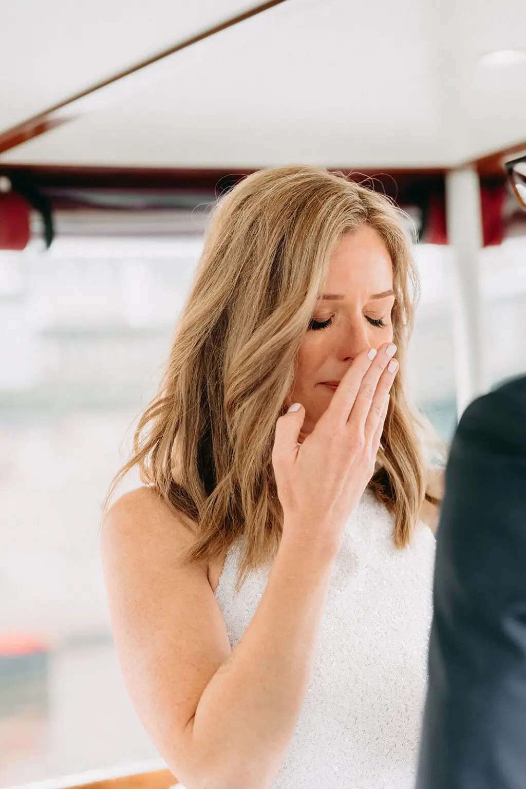 Bride becoming emotional while exchanging vows during a private canal boat wedding in Amsterdam