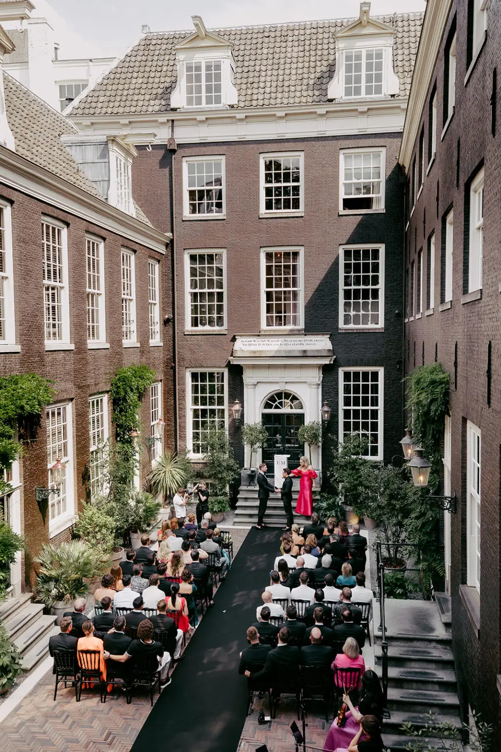 Outdoor wedding ceremony at The Dylan Hotel Amsterdam courtyard