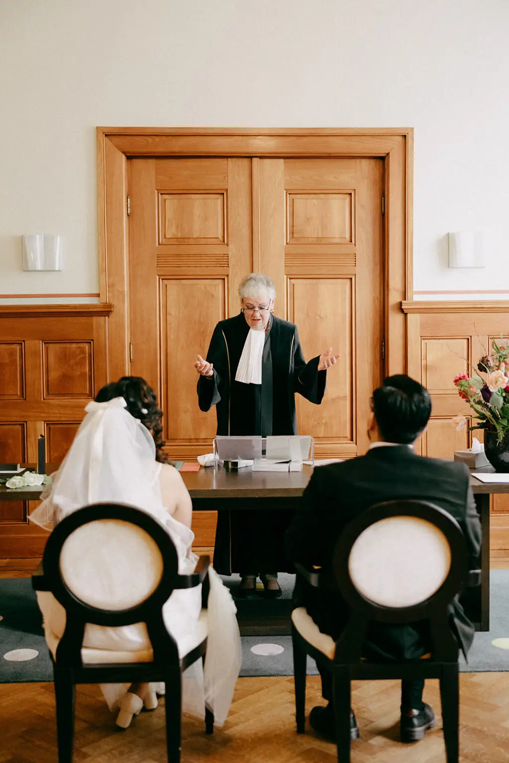 Civil wedding officiant speaking during a legal marriage ceremony in Amsterdam city hall