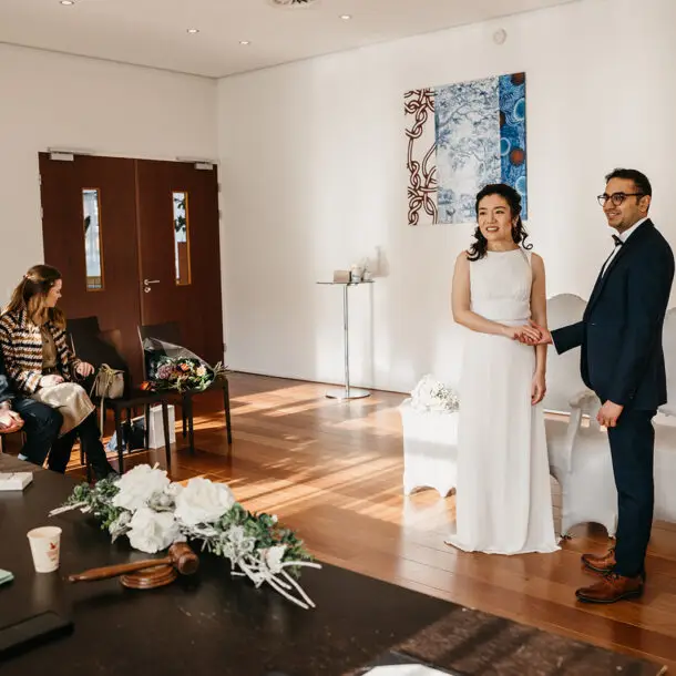 International couple standing during a small civil wedding ceremony in Amsterdam
