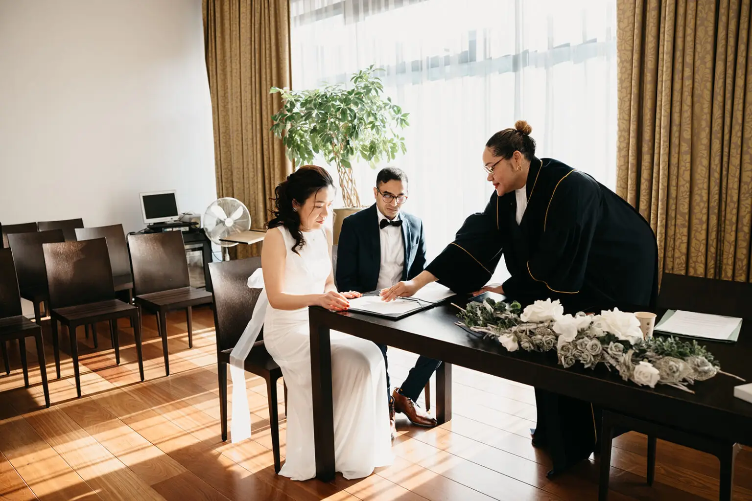 Wedding officiant assisting couple during a legal marriage ceremony in Amsterdam