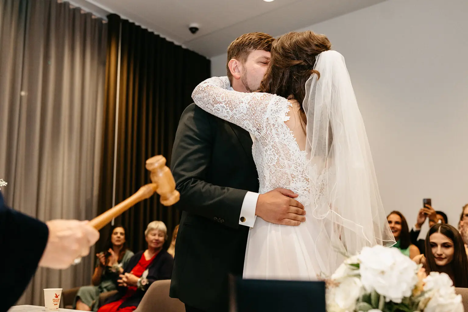 Bride and groom kissing after their legal wedding ceremony at Gemeente Amstel in Amsterdam