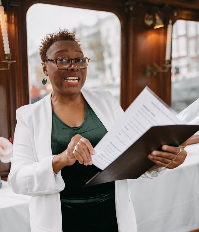 Wedding celebrant speaking during a canal boat ceremony in Amsterdam