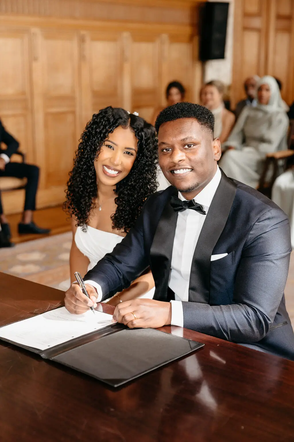 Couple signing marriage certificate during a legal wedding ceremony in Amsterdam