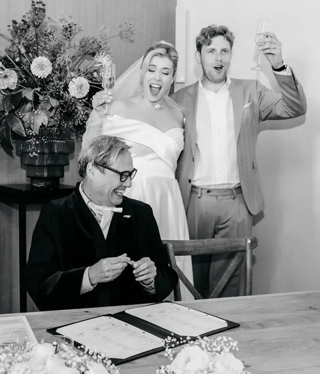 Couple celebrating after signing marriage documents during a legal wedding in Amsterdam