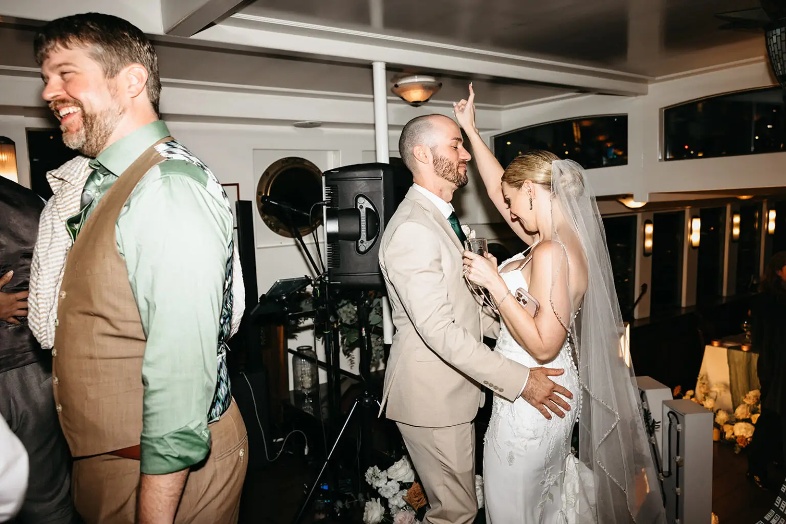 Bride and groom dancing together during the evening reception aboard an Amsterdam canal boat