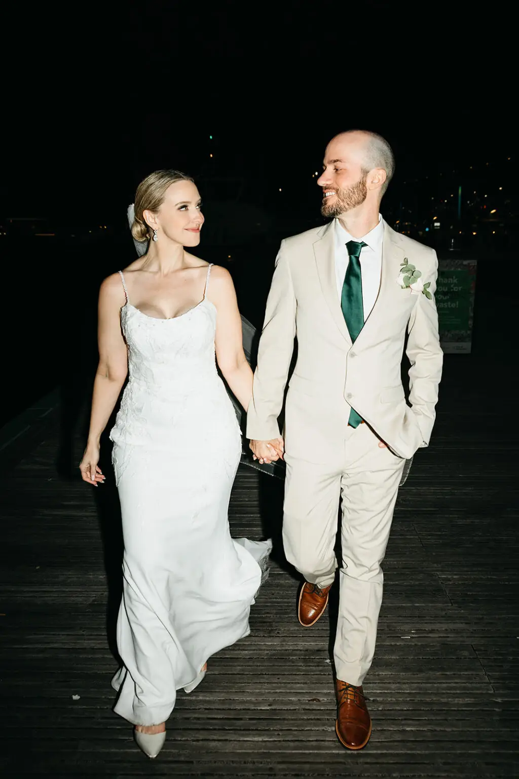 Bride and groom walking hand in hand on the waterfront after their Amsterdam destination wedding reception