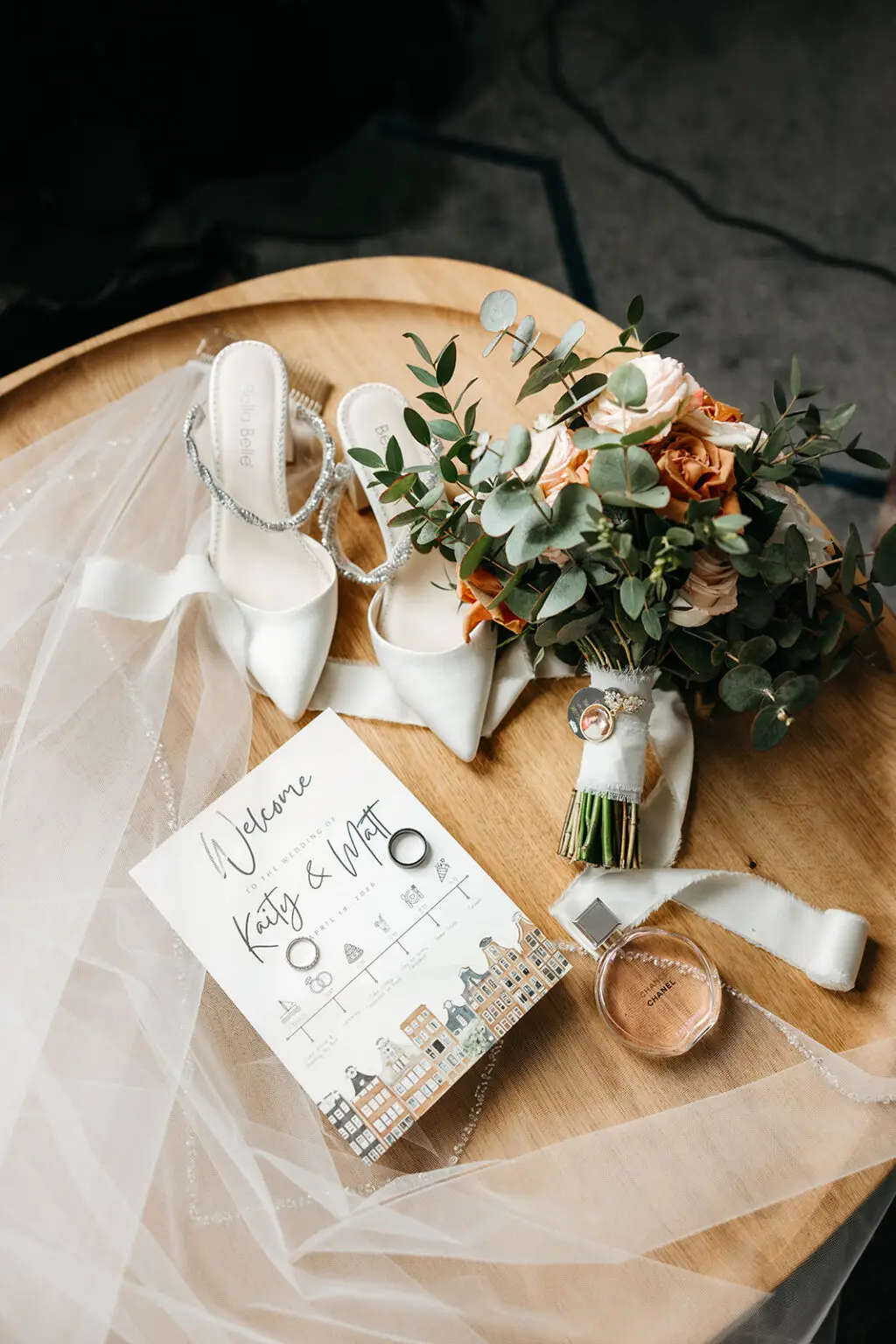 Wedding invitation, bridal bouquet, shoes, rings and accessories arranged before the ceremony in Amsterdam