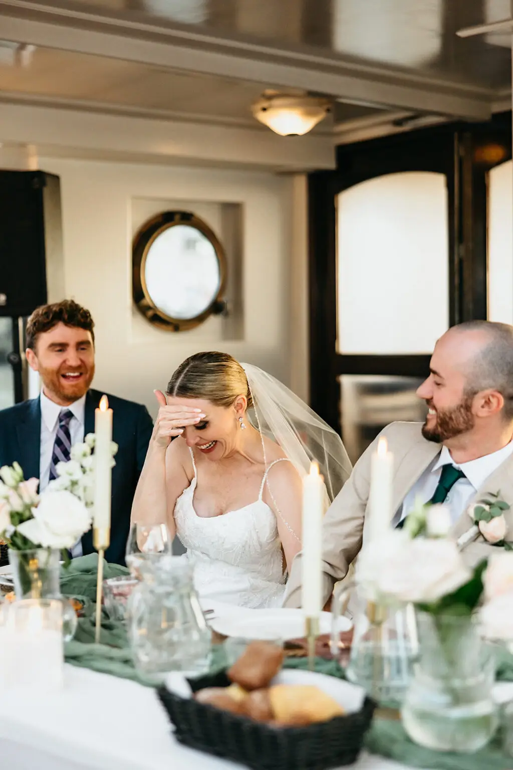 Bride and groom laughing during speeches at their Amsterdam canal wedding reception
