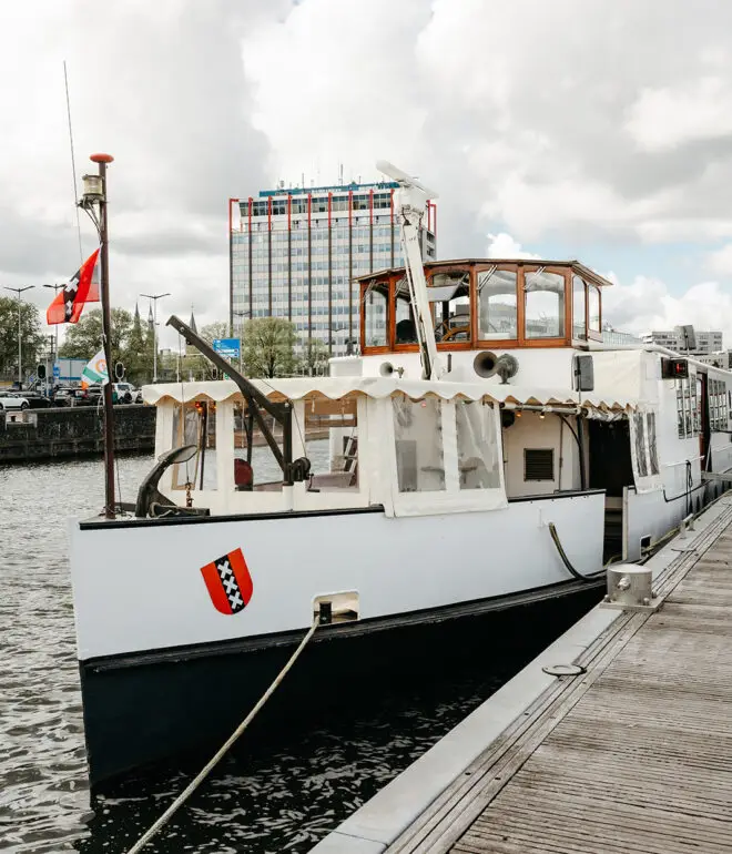 Historic Het Wapen van Amsterdam moored before a wedding ceremony on the Amsterdam waterfront