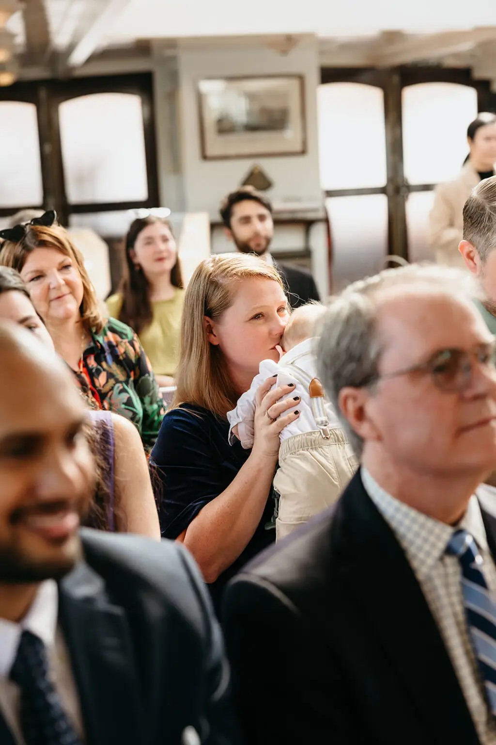 Family members watching an emotional wedding ceremony aboard Het Wapen van Amsterdam