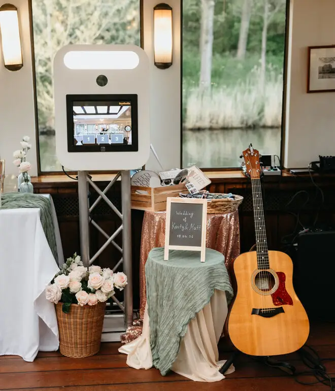 Photo booth and guest entertainment setup aboard an Amsterdam canal wedding boat during a destination wedding