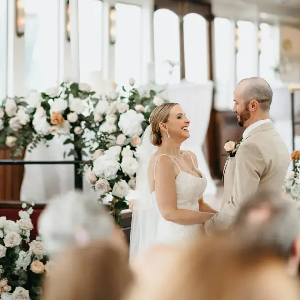 Bride and groom smiling together during their ceremony aboard Het Wapen van Amsterdam