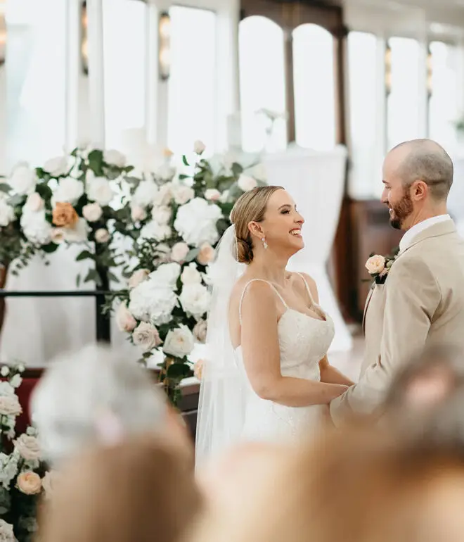 Bride and groom smiling together during their ceremony aboard Het Wapen van Amsterdam