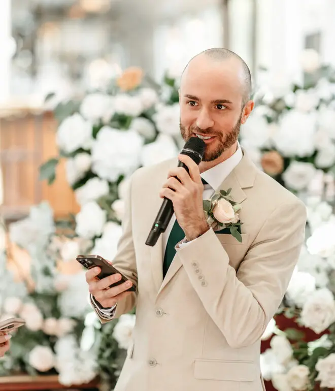 Groom reading personal vows during a symbolic wedding ceremony aboard Het Wapen van Amsterdam