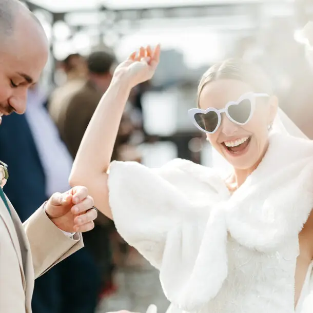 Bride and groom walking through a confetti exit after their ceremony aboard Het Wapen van Amsterdam