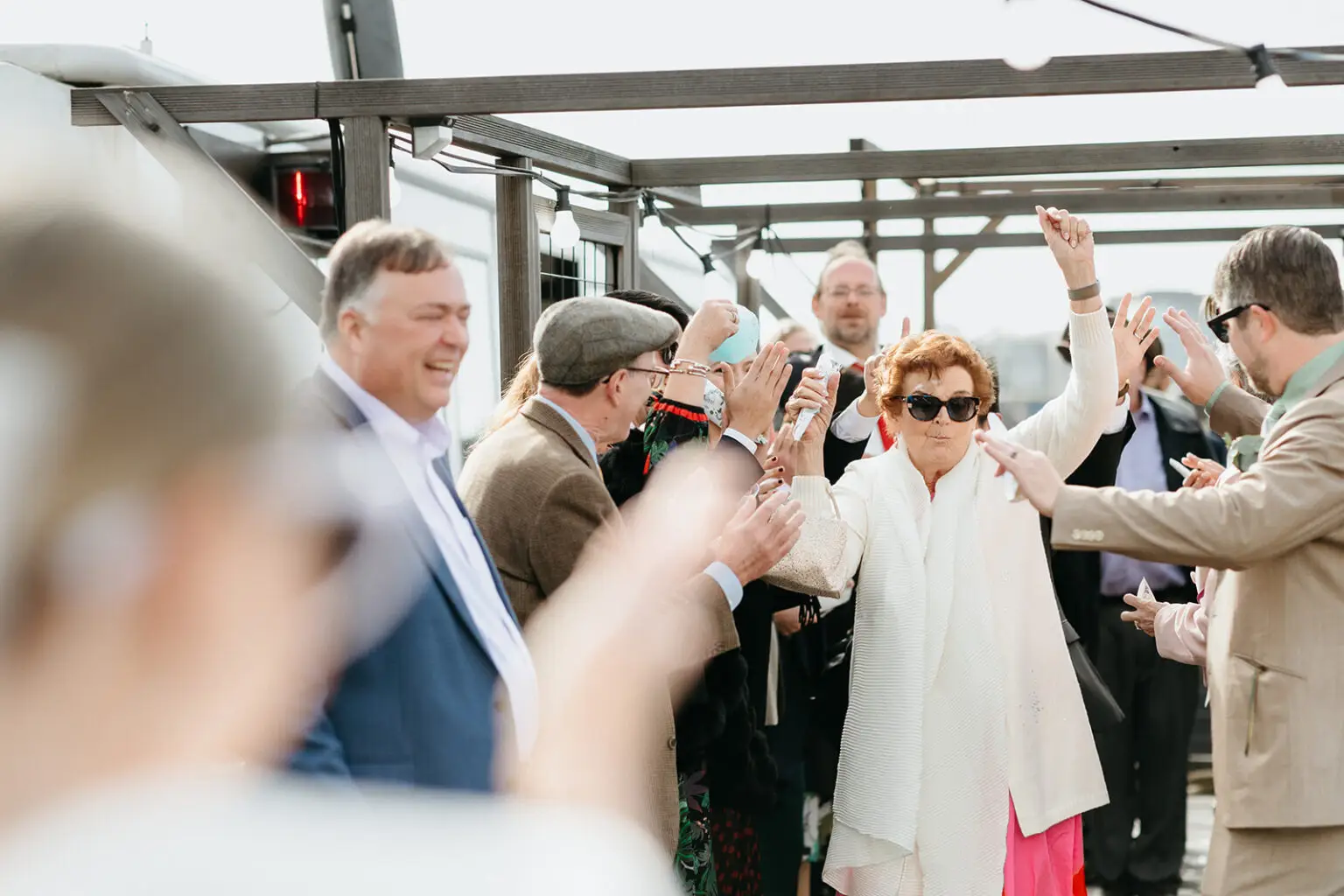 Wedding guests dancing and celebrating aboard an Amsterdam canal boat during a destination wedding reception