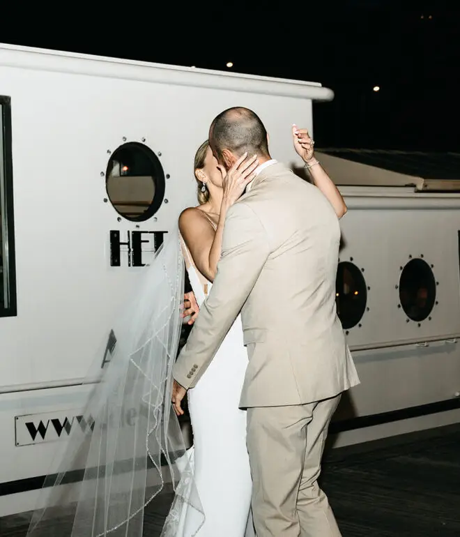 Bride and groom sharing their first dance aboard an Amsterdam canal boat during a destination wedding reception