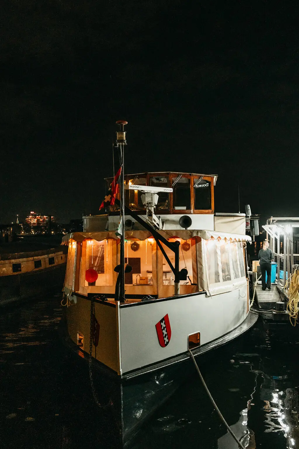 Private wedding boat moored on Amsterdam's canals after a destination wedding reception at night
